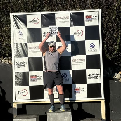 1st Place cyclist in front of podium