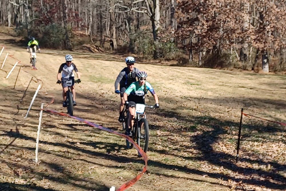 Four Cyclist racing downhill at the start of the Pedals & Pints cycling race
