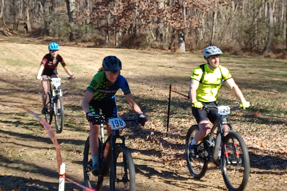 Three cyclist side by side on mountain bike race